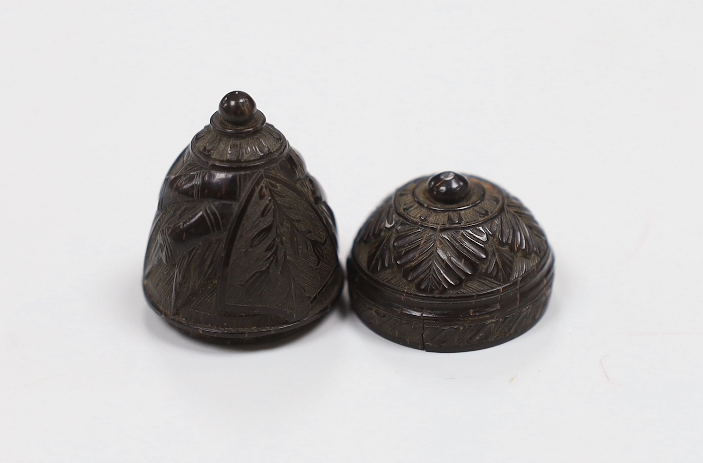 A 19th century sailor carved scrimshaw nut depicting an anchor and ship's cannon, 3.5cm high